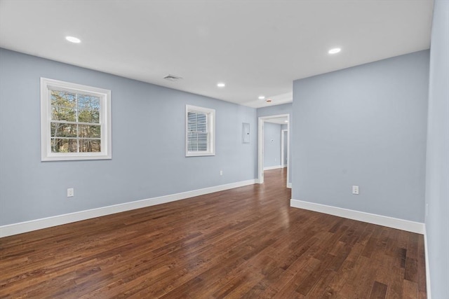 spare room featuring dark hardwood / wood-style flooring