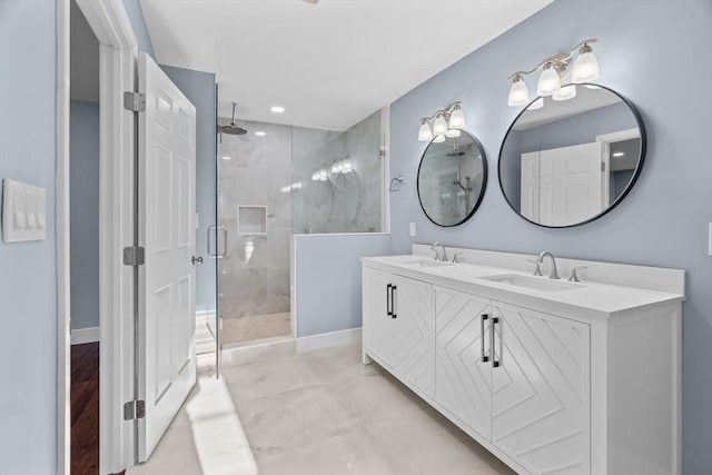 bathroom with ceiling fan, vanity, and an enclosed shower