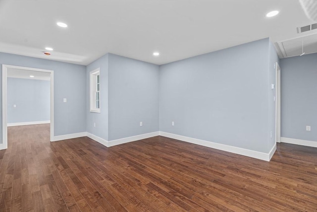 unfurnished room with dark wood-type flooring