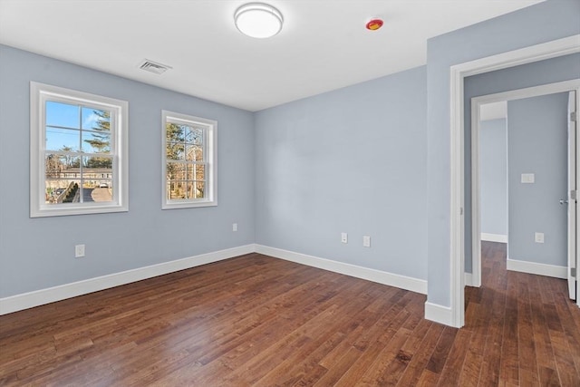 empty room featuring dark hardwood / wood-style floors