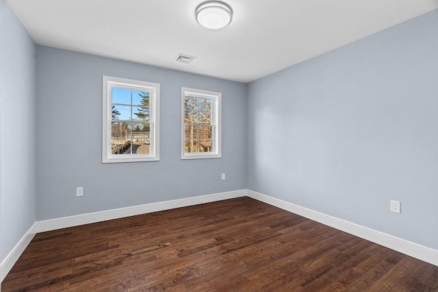 spare room with dark wood-type flooring