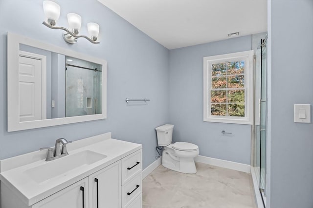 bathroom with vanity, an enclosed shower, and toilet