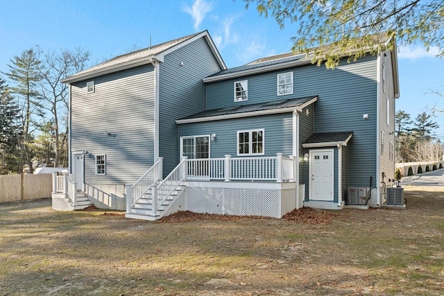 rear view of property featuring a deck and central AC unit