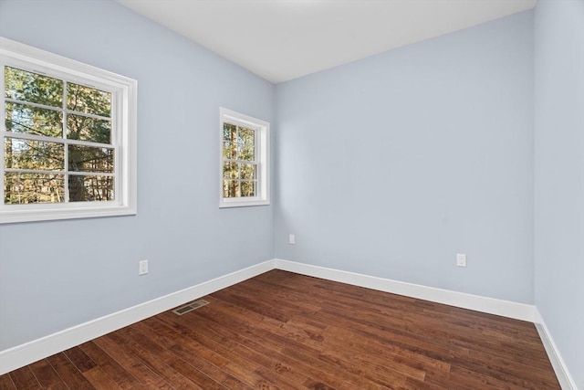 spare room featuring wood-type flooring