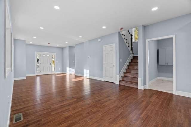 unfurnished living room with wood-type flooring