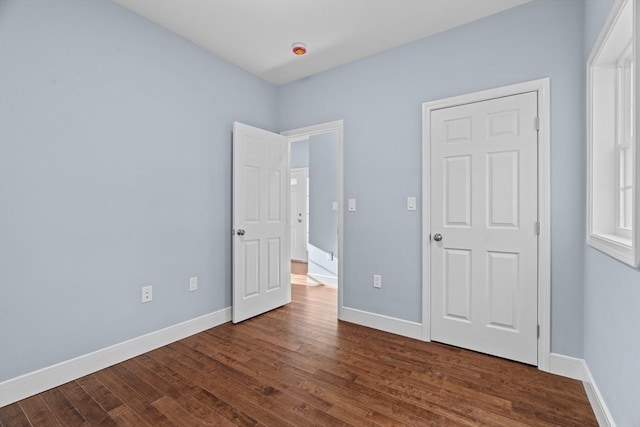 unfurnished bedroom featuring dark hardwood / wood-style flooring