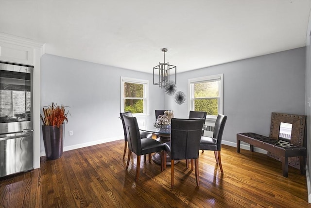 dining area featuring an inviting chandelier, baseboards, and dark wood-type flooring