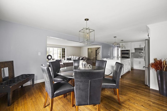 dining area featuring a chandelier, baseboards, and dark wood-type flooring