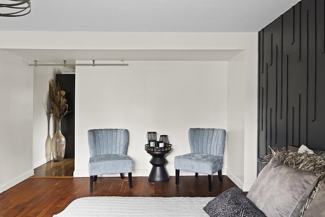 sitting room with wood finished floors and baseboards