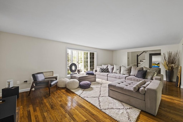living area featuring stairway and wood finished floors