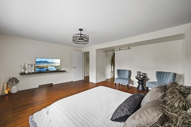 bedroom with baseboards and wood finished floors