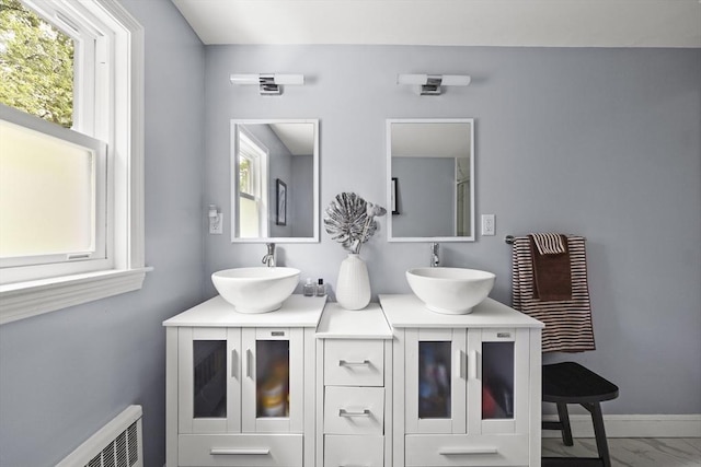 full bath with double vanity, a sink, and marble finish floor