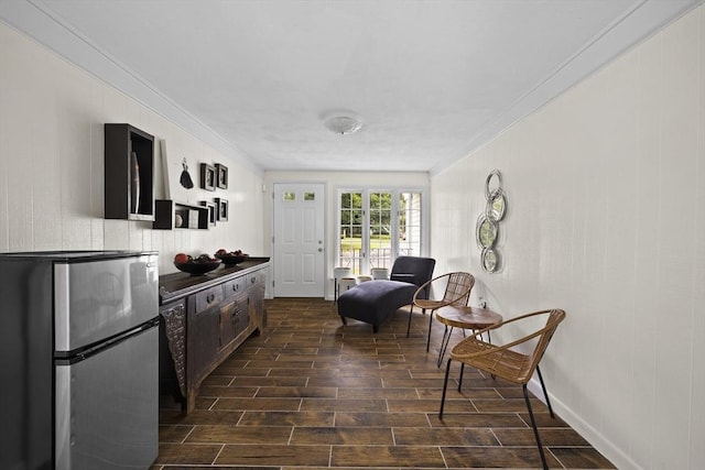 kitchen featuring ornamental molding, dark wood-style flooring, and freestanding refrigerator
