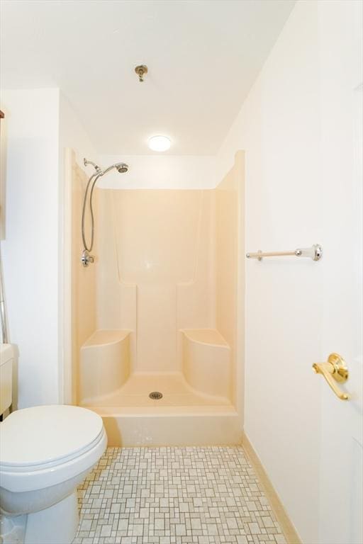 bathroom with a shower and toilet