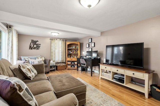 living room with beamed ceiling and wood finished floors