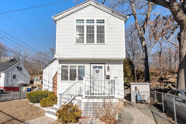 view of front of property featuring brick siding and fence