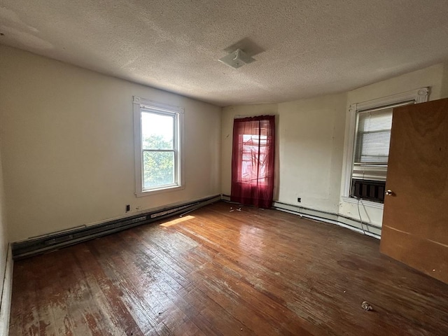 31 Rosedale St, Boston, MA 02124 - spare room with a baseboard radiator, wood finished floors, healthy amount of natural light, and a textured ceiling