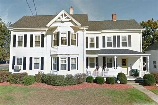 view of front of property with a porch and a chimney