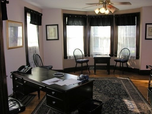 office area featuring a healthy amount of sunlight, ceiling fan, and wood-type flooring