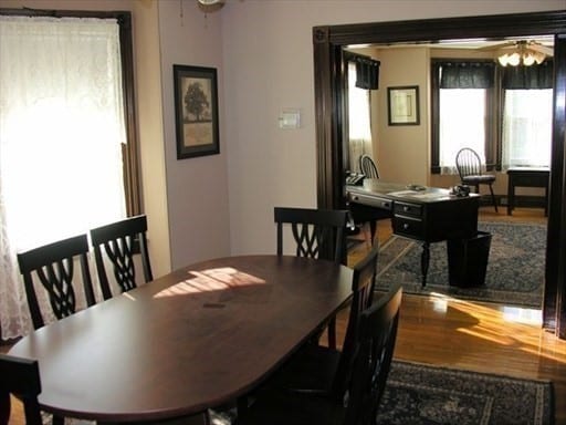 dining space featuring dark wood-type flooring and ceiling fan