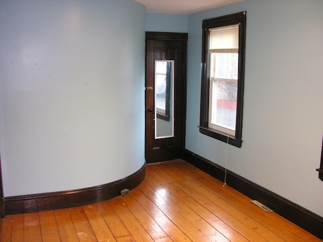 spare room with light hardwood / wood-style flooring