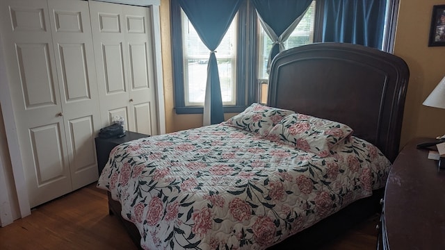 bedroom with a closet and dark hardwood / wood-style flooring