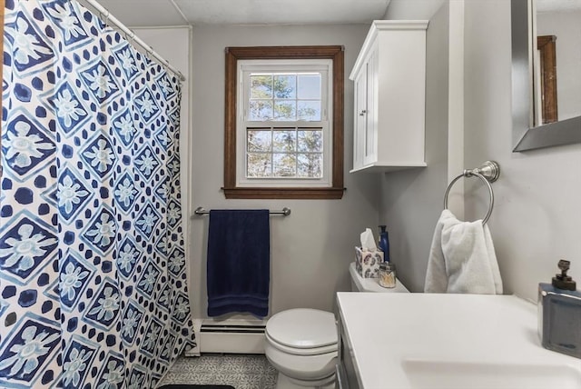 bathroom with vanity, baseboard heating, and toilet