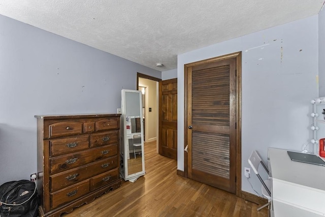 interior space with hardwood / wood-style floors and a textured ceiling