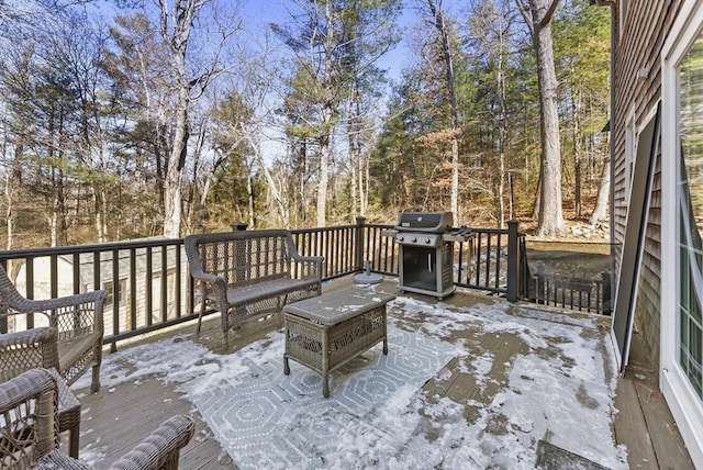 wooden deck featuring a grill