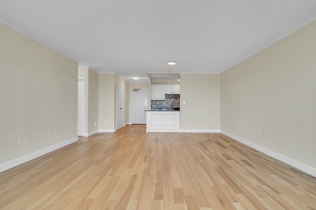 unfurnished living room with light wood-type flooring and crown molding