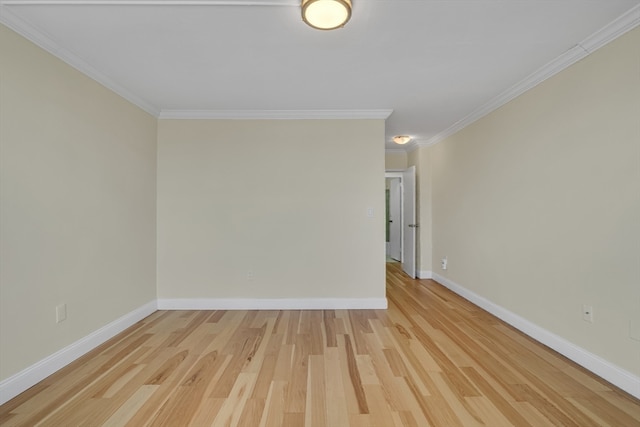 spare room featuring light wood-type flooring and ornamental molding