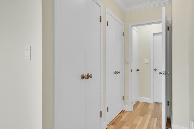 hall featuring light hardwood / wood-style flooring and ornamental molding