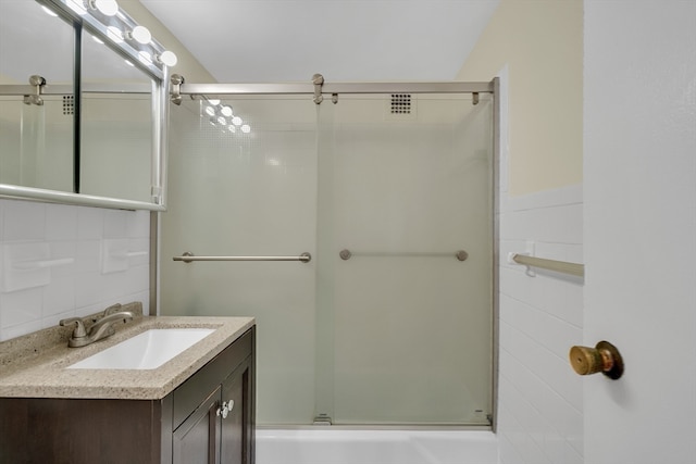 bathroom with enclosed tub / shower combo and vanity