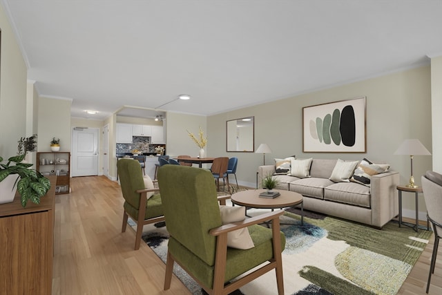 living room featuring light wood-type flooring and crown molding