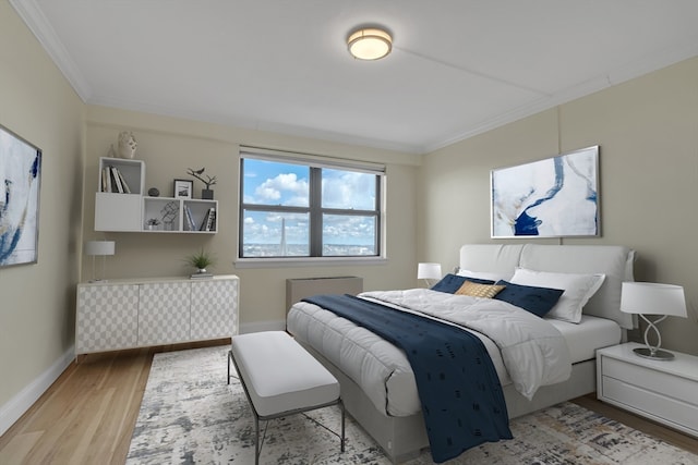 bedroom with light hardwood / wood-style floors and ornamental molding