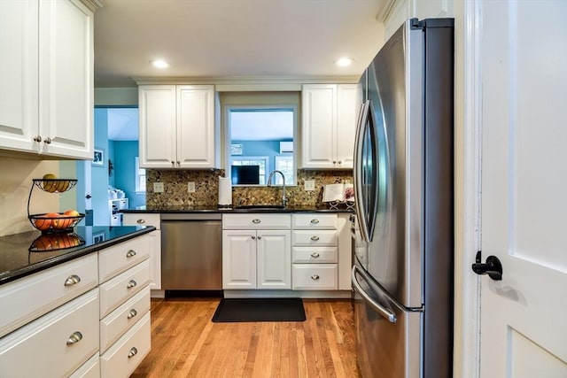28 Foster Dr, Framingham, MA 01701 - kitchen featuring stainless steel appliances, light wood-style flooring, white cabinets, tasteful backsplash, and recessed lighting