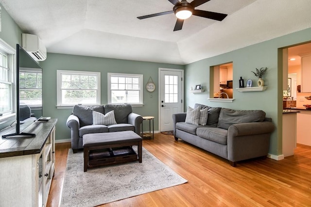 28 Foster Dr, Framingham, MA 01701 - living area featuring a wall mounted air conditioner, light wood finished floors, ceiling fan, a raised ceiling, and lofted ceiling