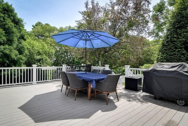 28 Foster Dr, Framingham, MA 01701 - wooden terrace with outdoor dining area, a grill, and view of wooded area