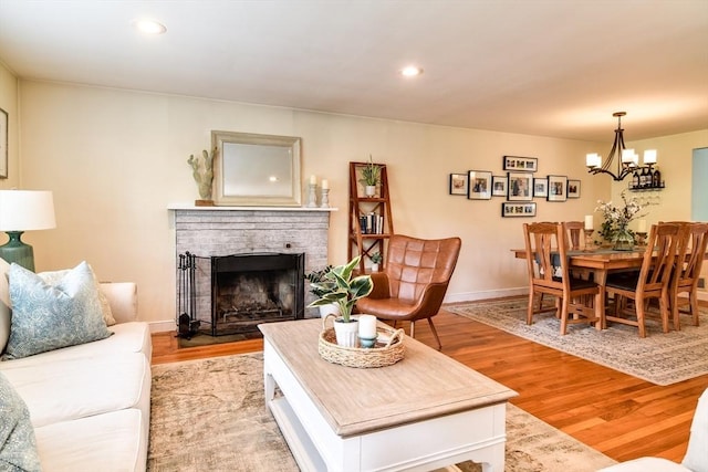 28 Foster Dr, Framingham, MA 01701 - living area with a chandelier, light wood-style floors, a brick fireplace, recessed lighting, and baseboards