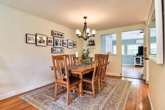 28 Foster Dr, Framingham, MA 01701 - dining space featuring wood finished floors, a chandelier, ceiling fan, and baseboards