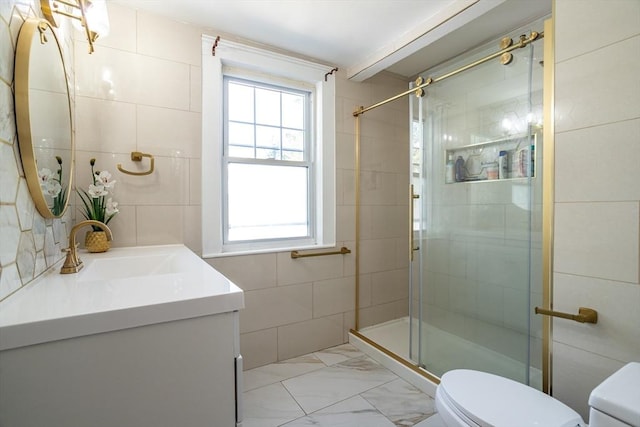 350 Wentworth Ave, Lowell, MA 01852 - full bathroom featuring toilet, a stall shower, vanity, marble look tiles, and tile walls