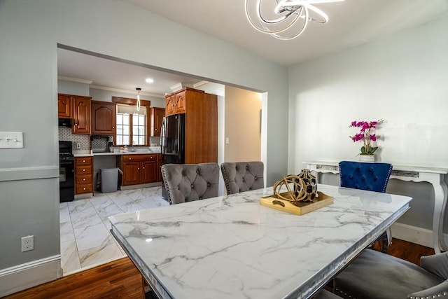 350 Wentworth Ave, Lowell, MA 01852 - dining space with a chandelier, ornamental molding, and baseboards