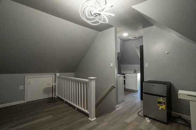 350 Wentworth Ave, Lowell, MA 01852 - additional living space featuring wood finished floors, vaulted ceiling, a chandelier, baseboards, and a sink