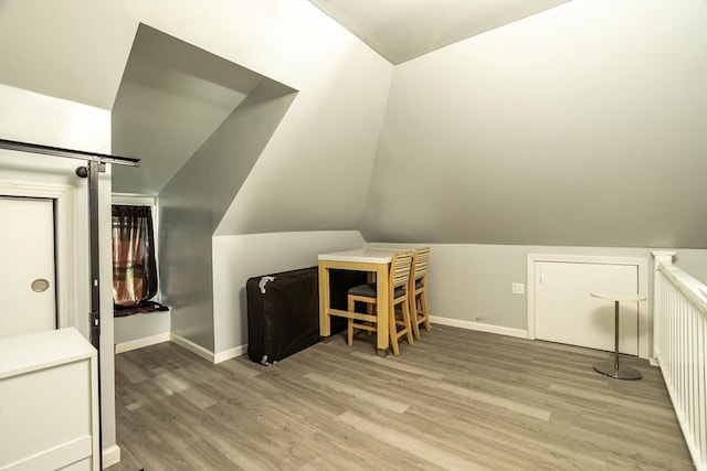 350 Wentworth Ave, Lowell, MA 01852 - additional living space with light wood-type flooring, baseboards, and lofted ceiling