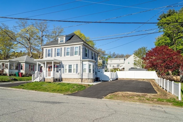 350 Wentworth Ave, Lowell, MA 01852 - view of front of house with driveway, fence, and a porch