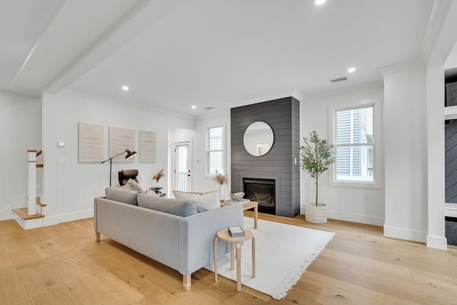 living room with a fireplace, light wood-style floors, stairway, baseboards, and recessed lighting