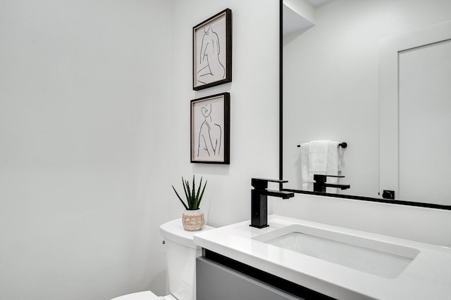 bathroom featuring toilet and vanity