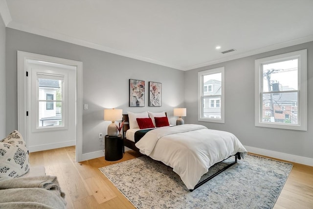 bedroom with ornamental molding, multiple windows, baseboards, light wood-type flooring, and recessed lighting