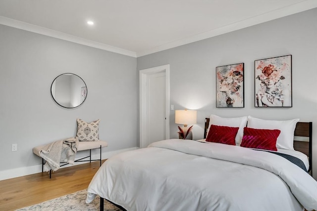 bedroom featuring wood finished floors and ornamental molding