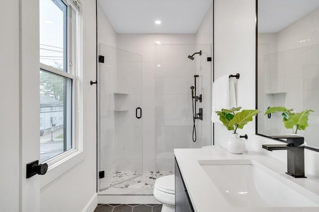 full bathroom featuring toilet, a stall shower, vanity, and tile patterned flooring